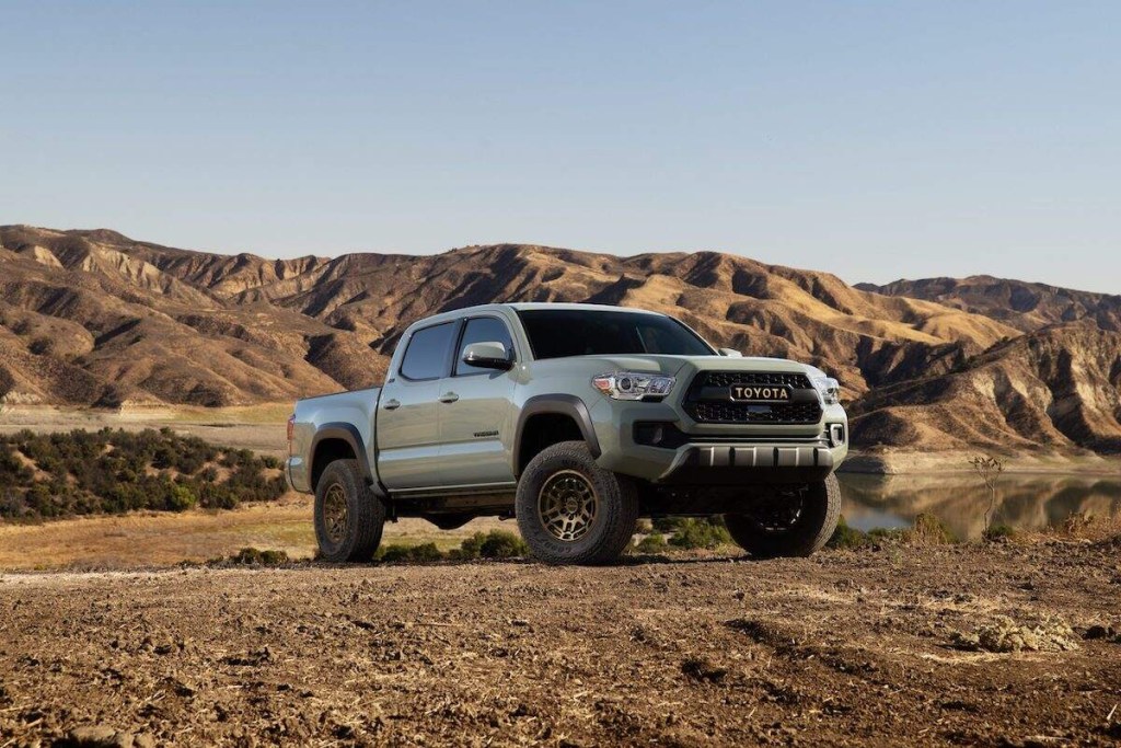 A silver 2023 Toyota Tacoma parked in a desert area. 