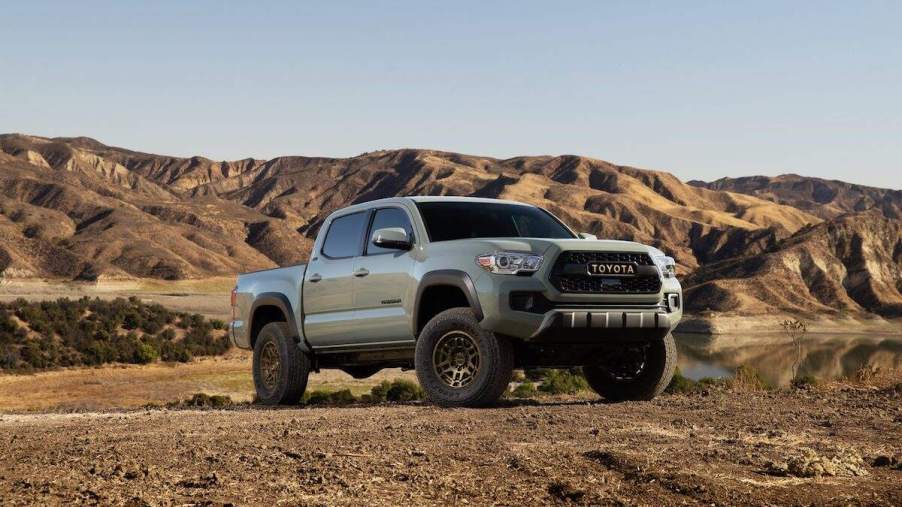 A silver 2023 Toyota Tacoma off-roading in sand. The Tacoma is the best midsize truck of 2023.