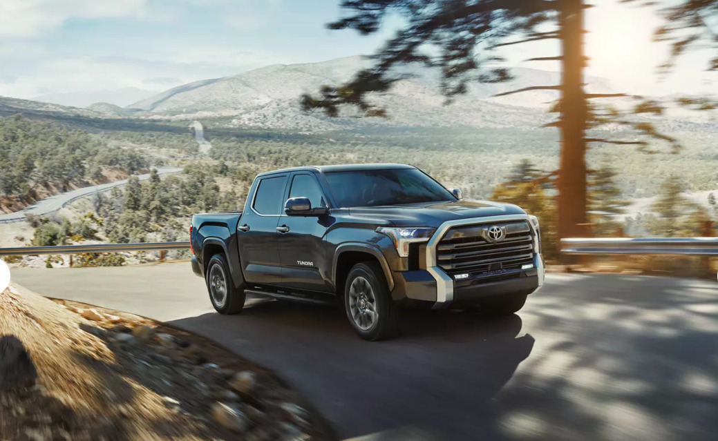 The 2023 Toyota Tundra driving up the road