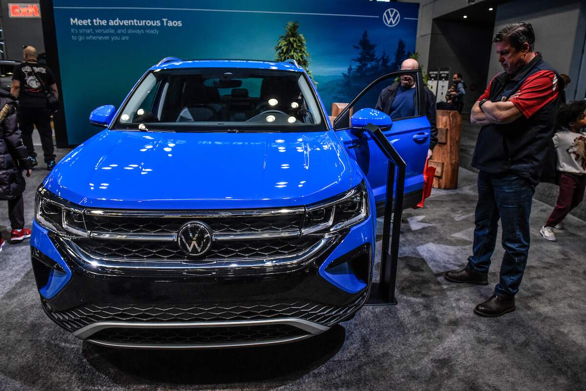 A blue 2023 Volkswagen Taos parked indoors.