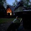 2023 Zero DSR/X parked in front of a cabin a dusk.