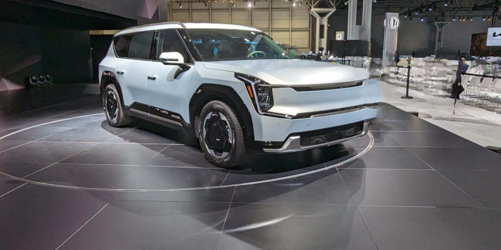 A blue 2024 Kia EV9 midsize electric SUV is parked at the 2023 New York International Auto Show.