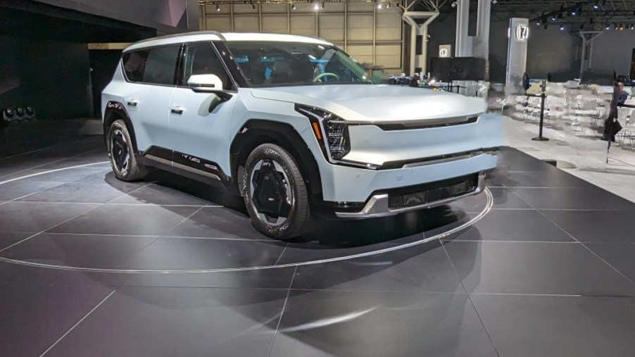 A blue 2024 Kia EV9 midsize electric SUV is parked at the 2023 New York International Auto Show.