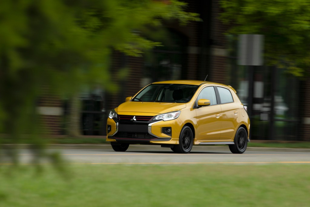 A yellow Mitsubishi Mirage driving