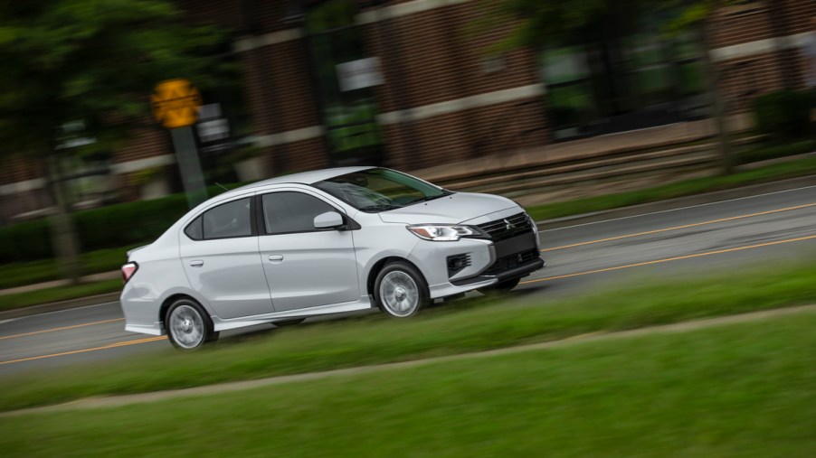 A silver Mitsubishi Mirage G4 driving on a city street