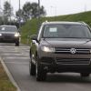A Volkswagen Touareg undergoes testing. An Audi follows behind in the background.