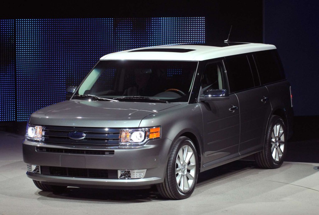 A silver Ford Flex on display at an auto show.