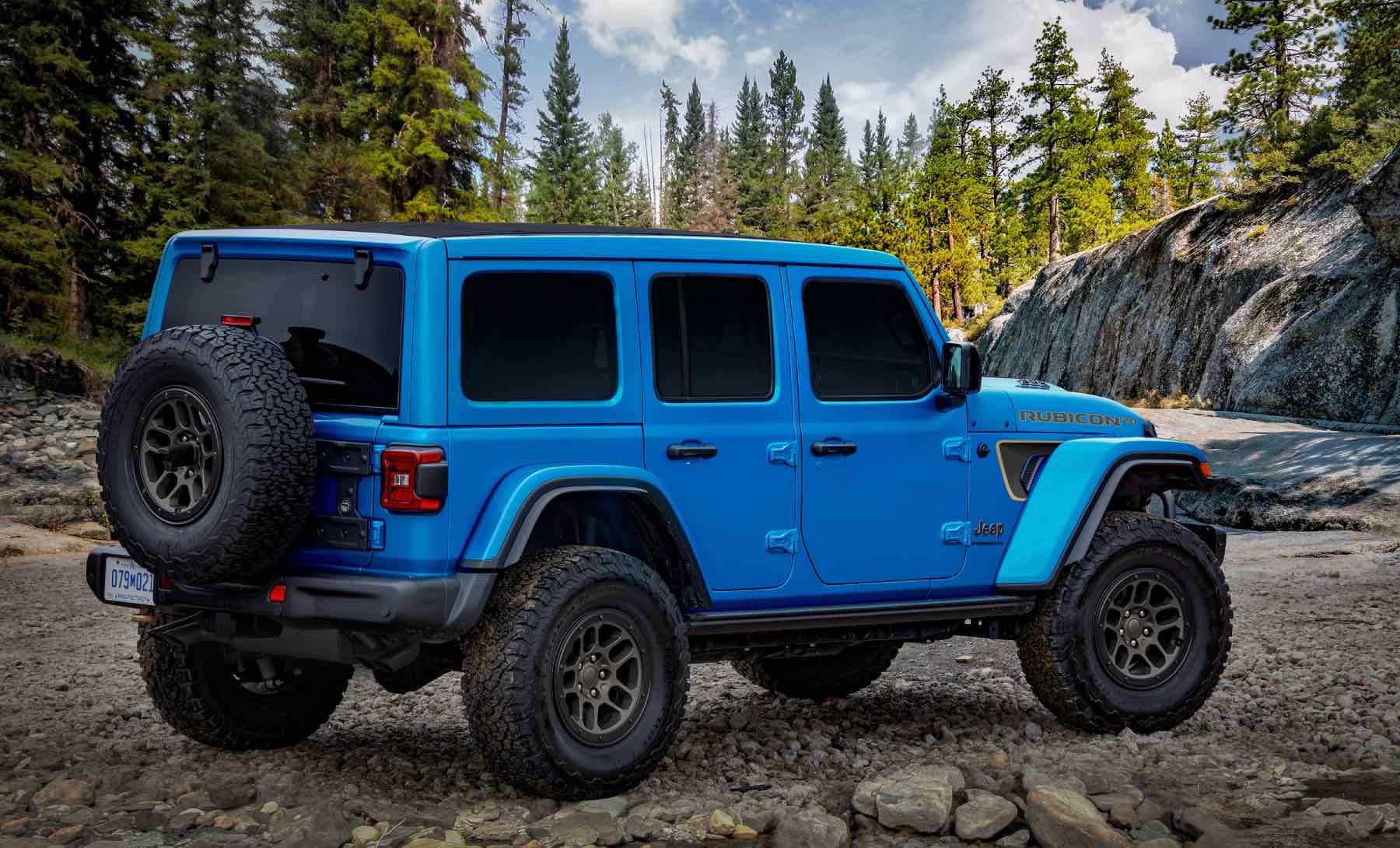 Rear view of a Jeep Wrangler Rubicon, ranked among the best SUVs for tall people, in an alpine forest.