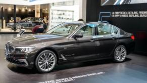 A black BMW 5 Series executive car model on display at the 95th European Motor Show in Brussels, Belgium
