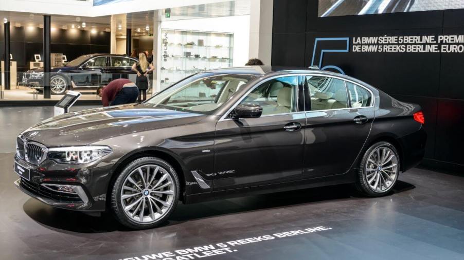 A black BMW 5 Series executive car model on display at the 95th European Motor Show in Brussels, Belgium