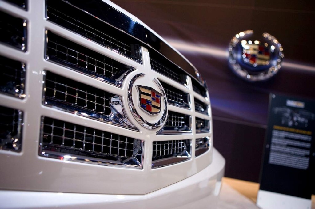 A close up of a white Cadillac Escalade on the grille with the logo displayed.
