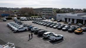 A new car lot, where mechanics could recommend used over new cars, with many options parked across the lot.