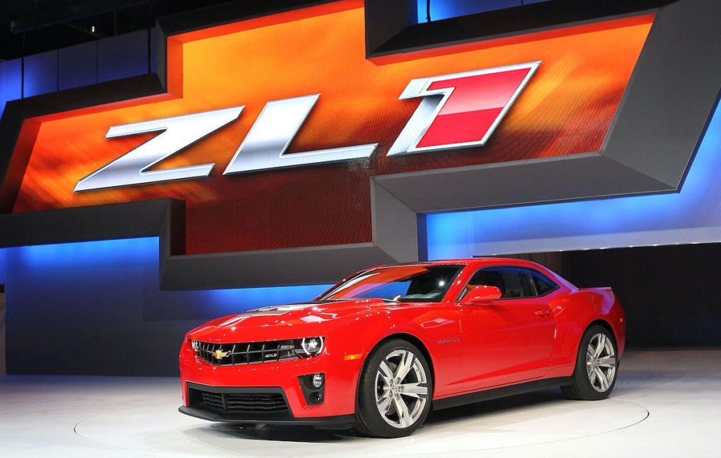 A red Chevrolet Camaro ZL1 in red at an auto show.