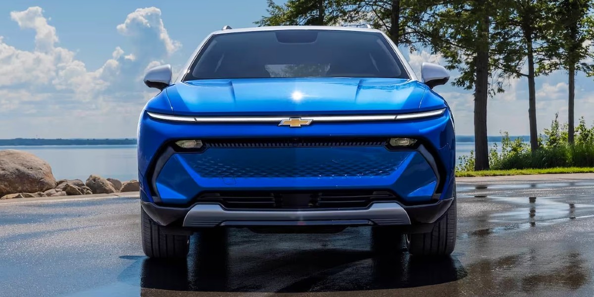 A blue 2024 Chevy Equinox EV small electric SUV is parked.