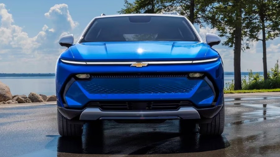 A blue 2024 Chevy Equinox EV small electric SUV is parked.
