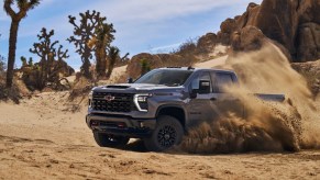A 2024 Chevy Silverado 2500HD ZR2 heavy-duty truck drives off-road.