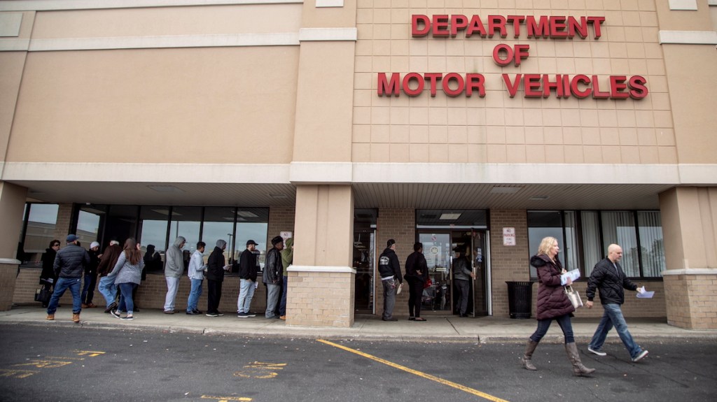 People Wait Outside a Department of Motor Vehicles Office