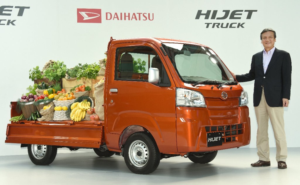 A Daihatsu Hijet shows off as a Kei truck with fruit in its bed.