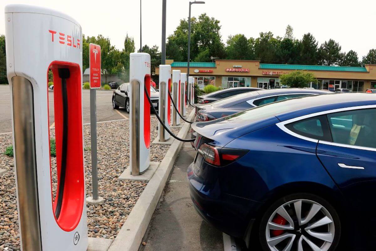 Tesla EVs lined up at Ev charge stations