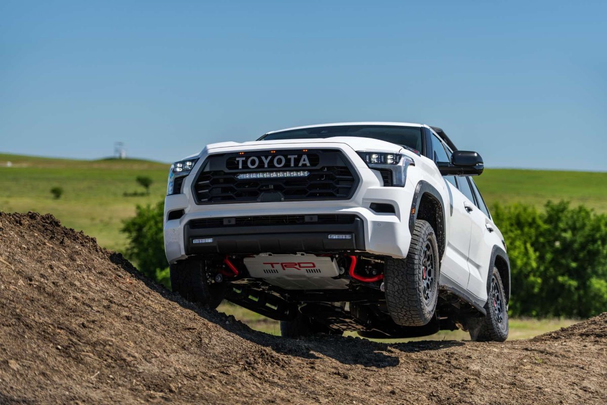 A white 2023 Toyota Sequoia TRD Pro demonstrates its capabilities on an off-road trail.