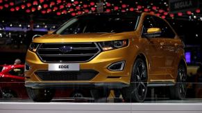 A yellow/gold Ford Edge midsize SUV model presented at the 2015 Geneva Motor Show in Switzerland