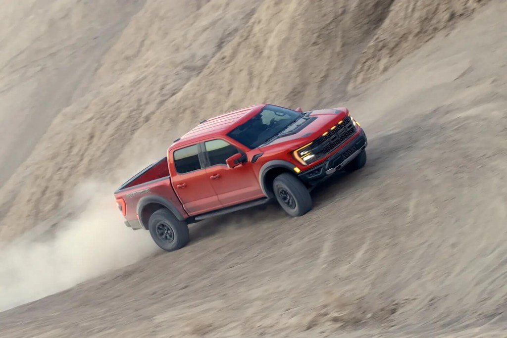 A 2023 Ford F-150 Raptor drives off-road as a half-ton pickup.