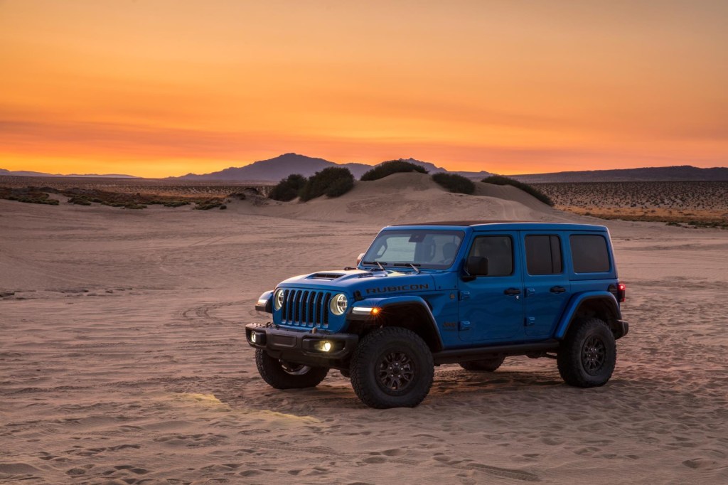 The Jeep Wrangler JL 392 Rubicon sits sits in a desert landscape at sunset. 