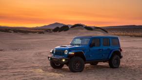 The Jeep Wrangler JL 392 Rubicon sits sits in a desert landscape at sunset.