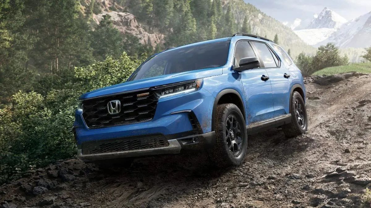 Front angle view of blue 2023 Honda Pilot TrailSport off-road midsize SUV