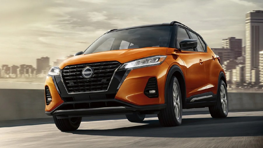 Front angle view of orange 2023 Nissan Kicks subcompact SUV, cheapest new Nissan SUV in 2023