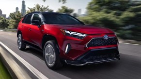 Front angle view of red 2023 Toyota RAV4 Prime plug-in hybrid compact crossover SUV.