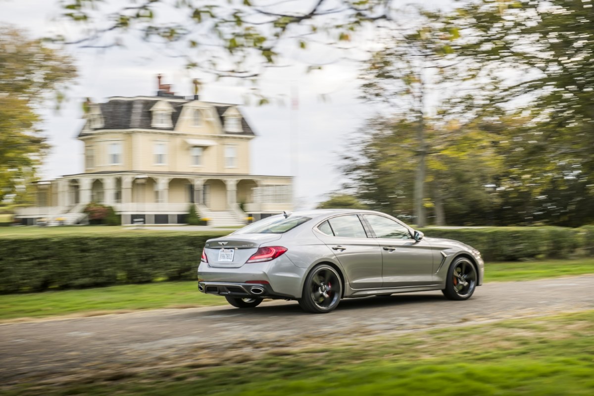 2019 Genesis G70 from the rear driving past a Victorian house