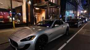 A silver Maserati GrandTourismo parked on a dark street