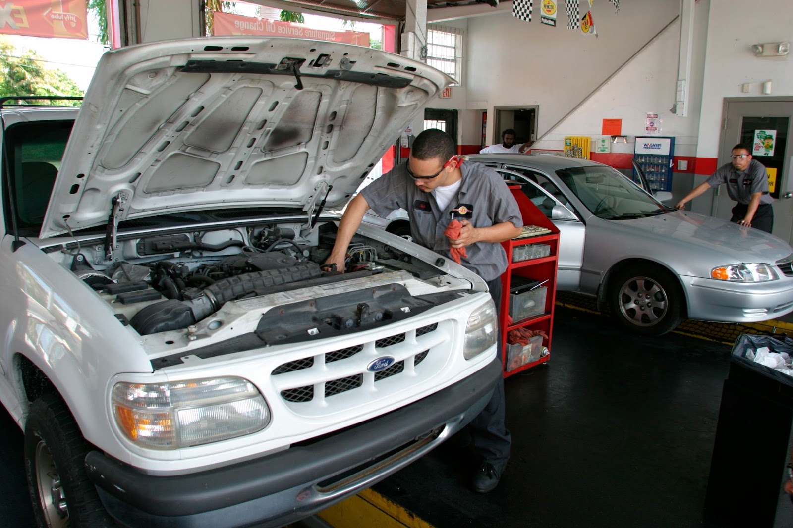 A mechanic performs an oil change