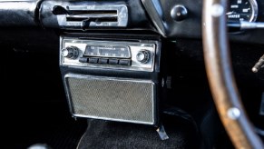 A radio in a 1961 Aston Martin is a solid example of relaxing ASMR sources in classic cars.