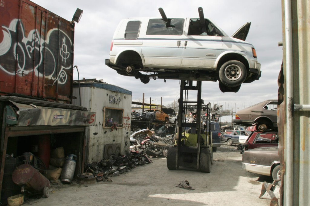 A Chevy Astro van at a junkyard in New York City.