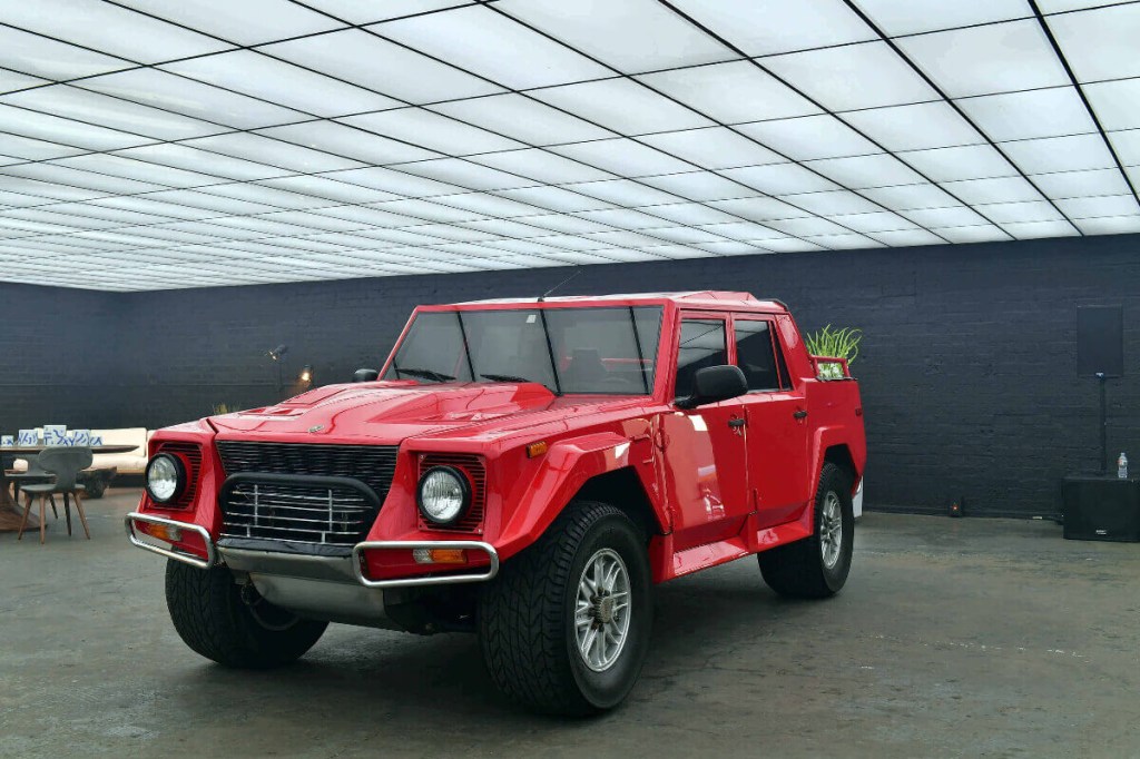 A red Lamborghini supertruck, the LM002 is on display.