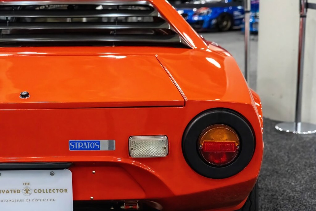 A Stratos rally car shows off its rear lights.
