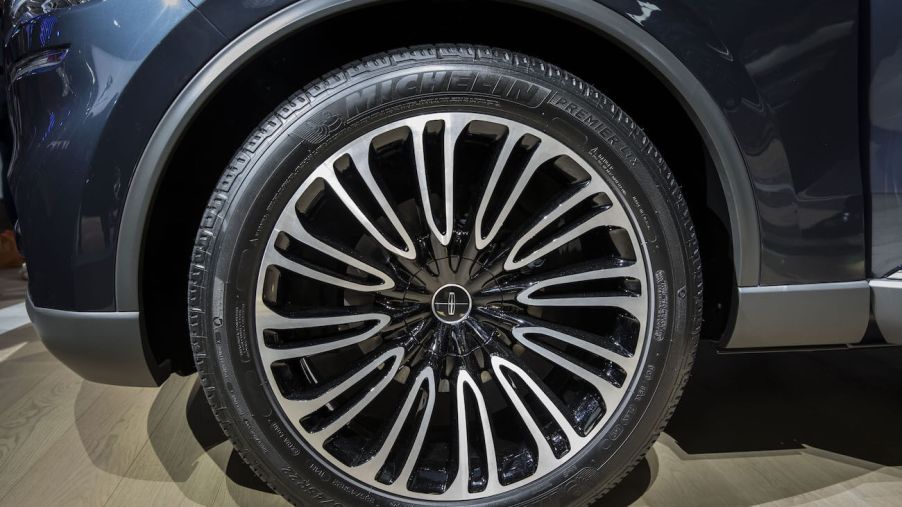 The Ford Motor Co. logo sits on the wheel hub of a Lincoln Aviator sports utility vehicle (SUV) as it stands on display at the Beijing International Automotive Exhibition in Beijing, China