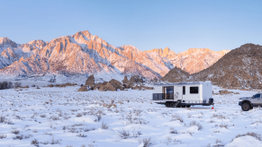 The Living Vehicle HD-Pro in a snow field. This is the most expensive camper trailer on the market.