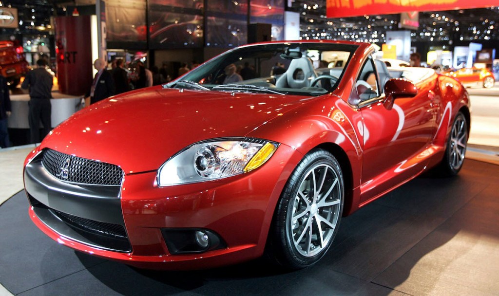 A red Mitsubishi Eclipse convertible at an auto show