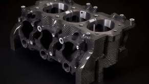 Bare Nissan carbon fiber engine block against black background