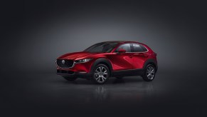 2023 Mazda CX-30 in red on a dark background.