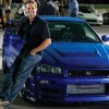 Paul Walker Leaning on the Blue Nissan Skyline R34 during filming of the fourth Fast and Furious movie