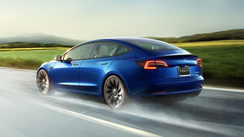Rear angle view of blue Tesla Model 3, highlighting lawsuit claiming Model 3 Autopilot defect caused deaths