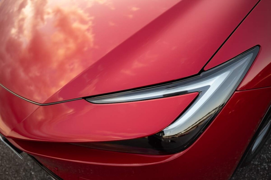 A red Toyota Prius headlight, which is one of the most reliable used cars for the money. 