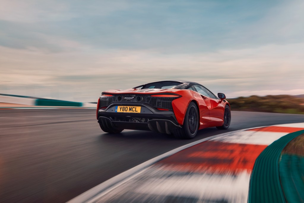 The back end of a McLaren Artura on a racetrack at speed