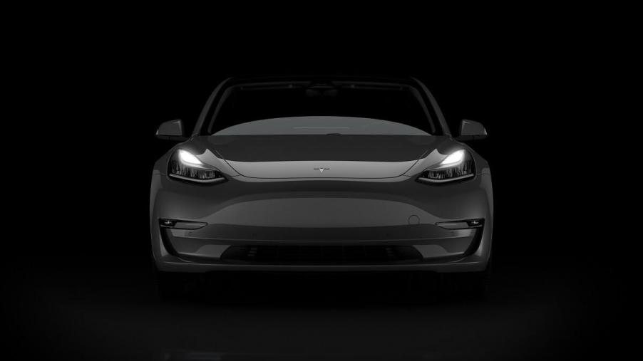 A black 2023 Tesla Model 3, one of the fastest cars in the world for the price, shows off its front-end.