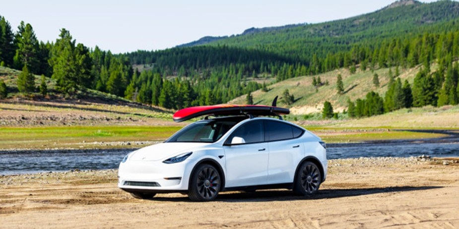 A white 2023 Tesla Model Y is parked outdoors. 