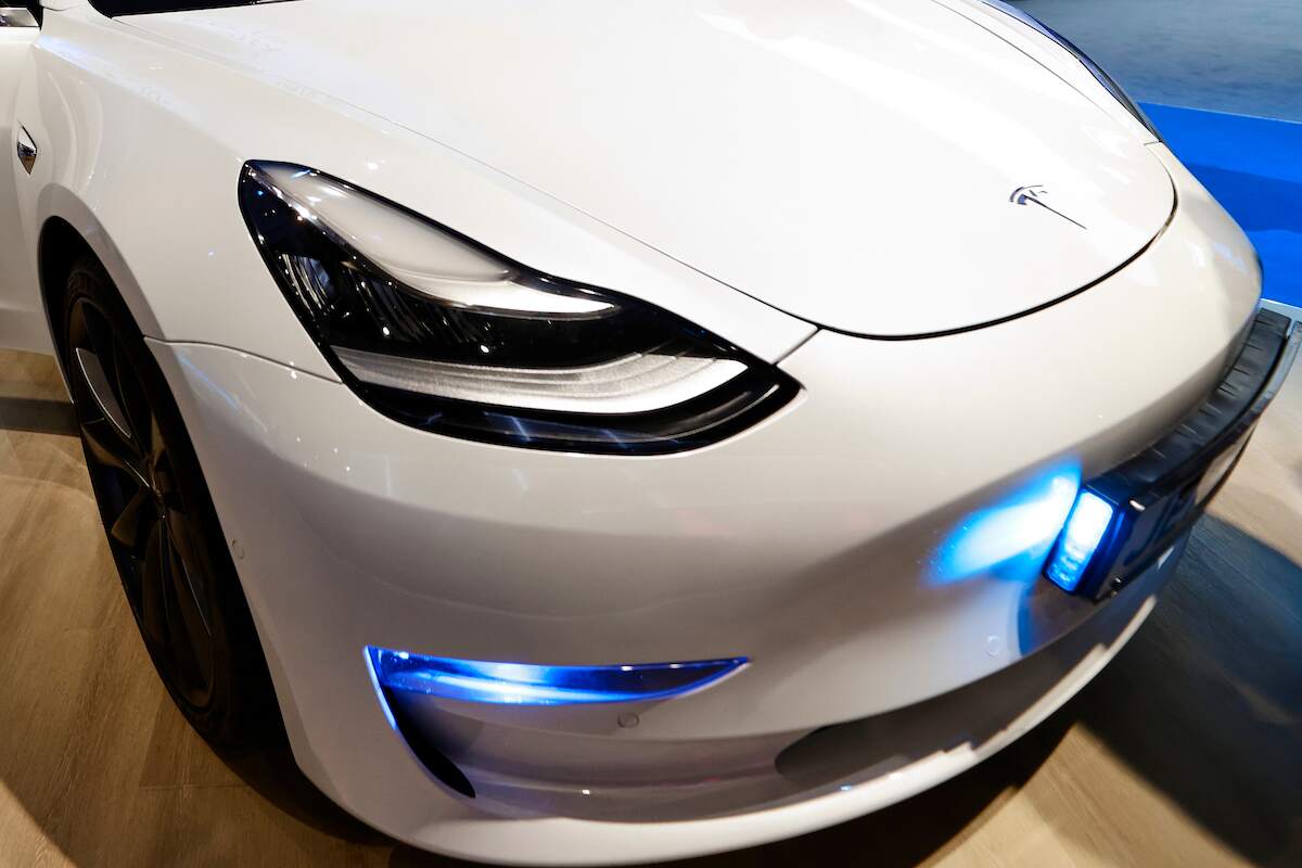 A white Tesla Model S headlight close up.